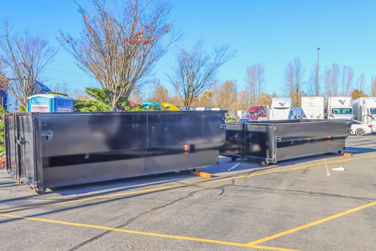Professional dumpster rental service with roll-off container on residential driveway in Wheatfield
